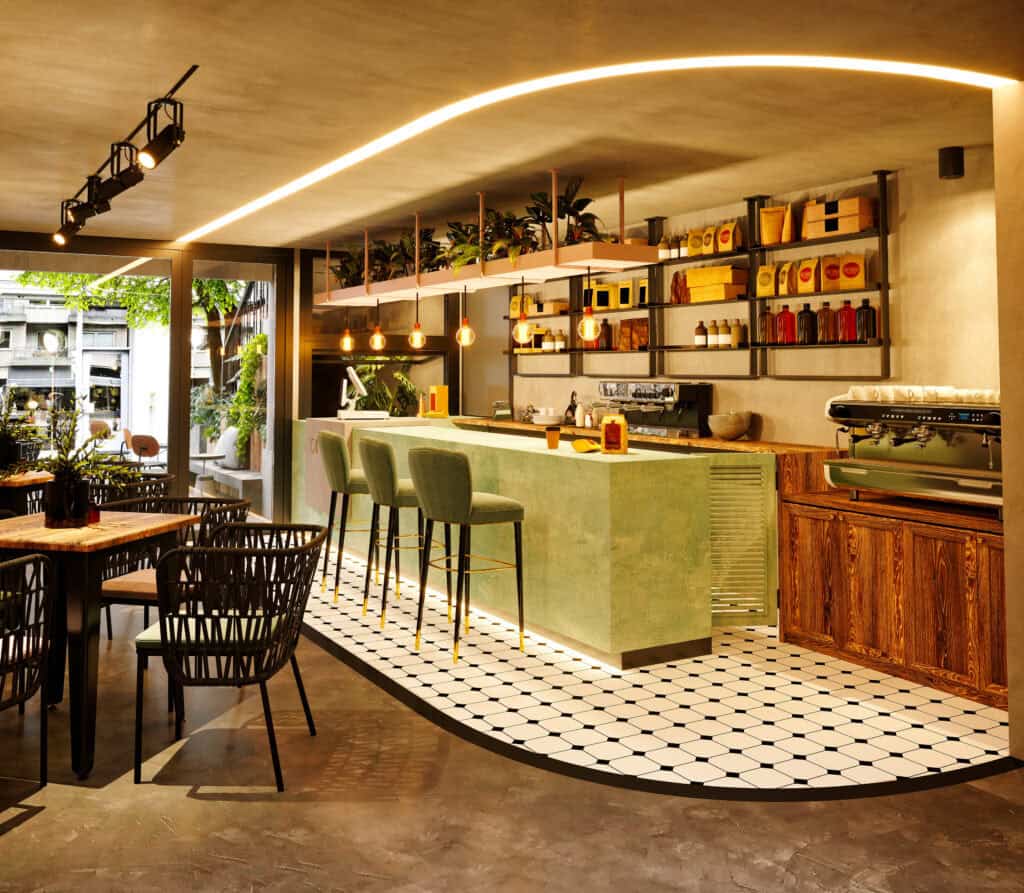 Moderne horeca-inrichting met groene bar, velvet barkrukken en sfeervolle verlichting