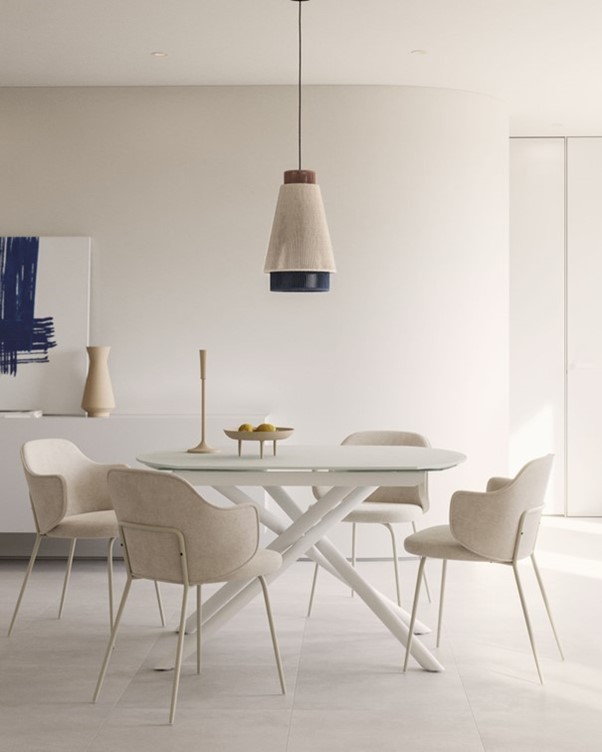 Zandkleurige bouclé eetkamerstoelen aan ronde tafel in minimalistisch interieur met zachte vormen