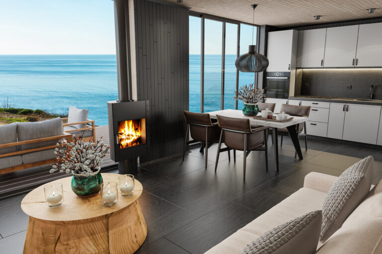 Keuken en woonkamer in een vakantiewoning met houten details, ruime eettafel en uitzicht op zee.