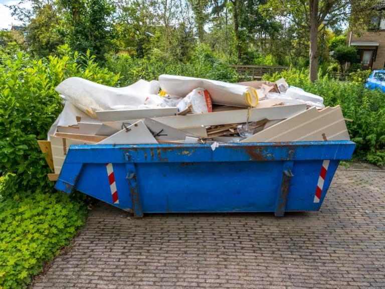 Puincontainer op oprit bij woning tijdens verbouwing